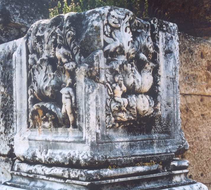 Carving on a pillar of acathus leaves and small people